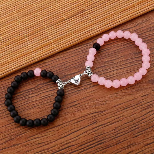 A Pair Of Pink And Black Beaded Bracelets, Perfect For Couples' Daily Wear Or As A Gift For Friends.